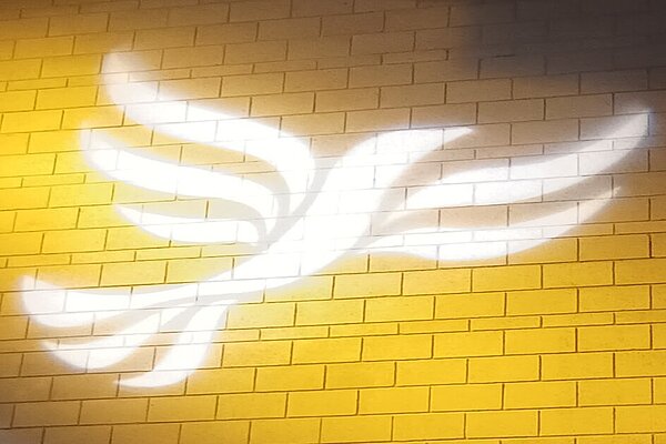 A skyline of Norwich in silhouette with the Liberal Democrat logo overlaid