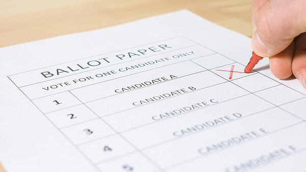 A mockup ballot paper with an X being marked next to a candidate