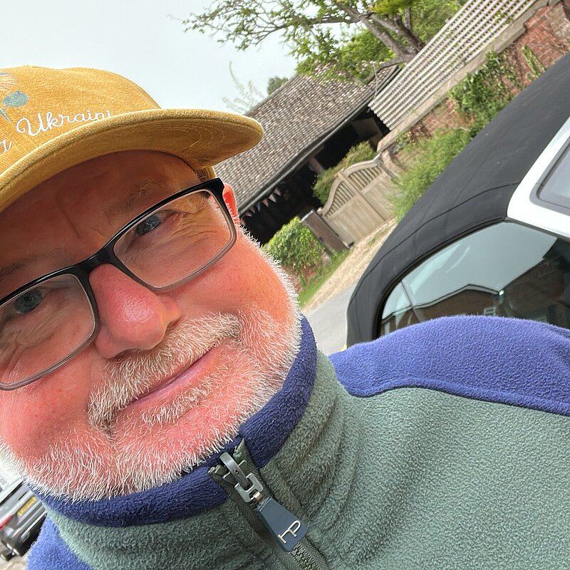 Graham Whiting wearing casual green top and gold cap