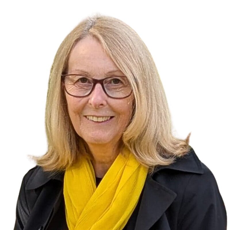 Head and shoulders photo of Jacqui Morley wearing yellow scarf