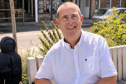 Ian Taylor sat on a bench