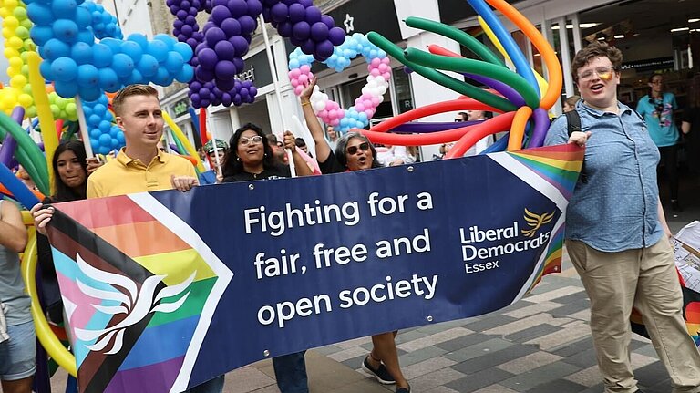 Essex Lib Dems holding a banner in a Pride march